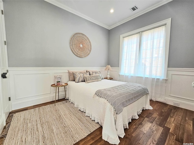 bedroom with ornamental molding and dark wood-type flooring