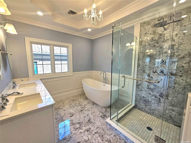 bathroom featuring plus walk in shower, vanity, a chandelier, and ornamental molding