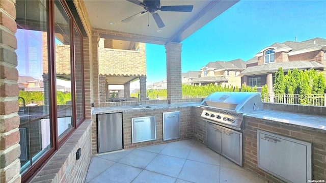 view of patio / terrace with a grill, ceiling fan, and exterior kitchen