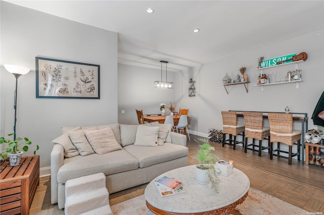 living room featuring parquet flooring and indoor bar