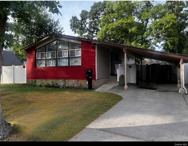 view of front of house with a front lawn and a carport