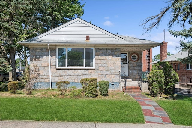 bungalow-style house featuring a front yard