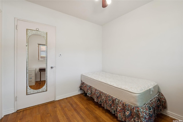 bedroom with dark hardwood / wood-style floors and ceiling fan