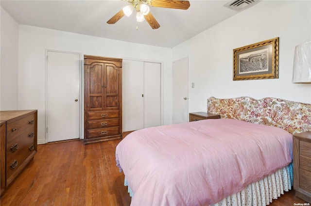 bedroom featuring a closet, ceiling fan, and dark wood-type flooring