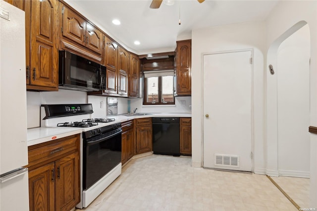 kitchen with black appliances, ceiling fan, and sink