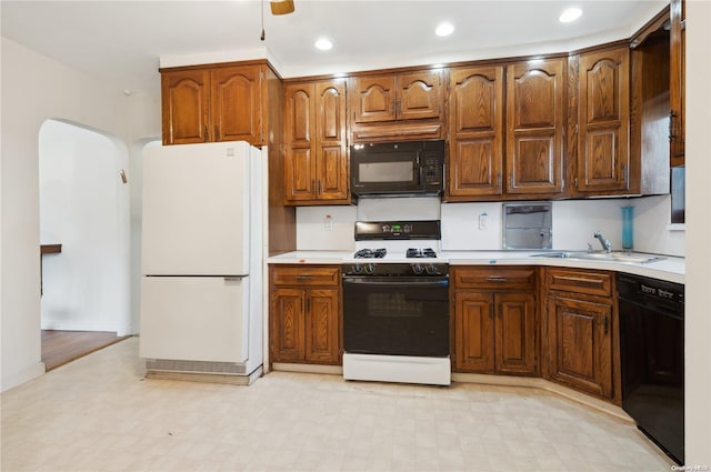 kitchen with ceiling fan, sink, and black appliances