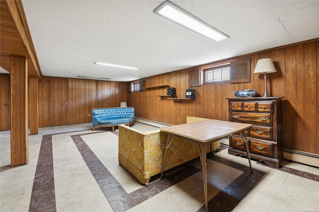 interior space with wood walls and a baseboard heating unit