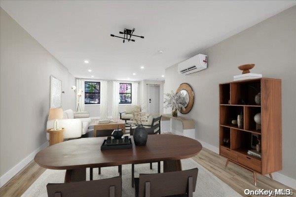 dining room featuring light hardwood / wood-style floors and an AC wall unit