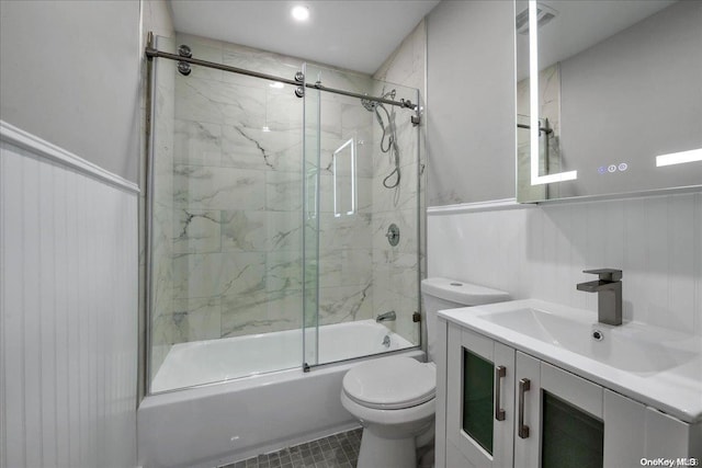 full bathroom featuring vanity, toilet, and combined bath / shower with glass door