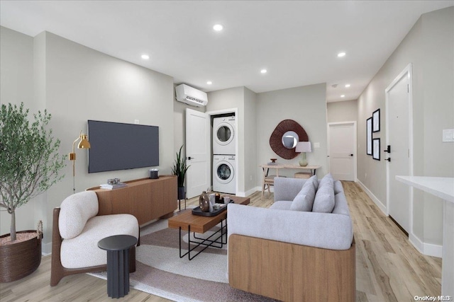 living room featuring light wood-type flooring, a wall mounted AC, and stacked washer and clothes dryer