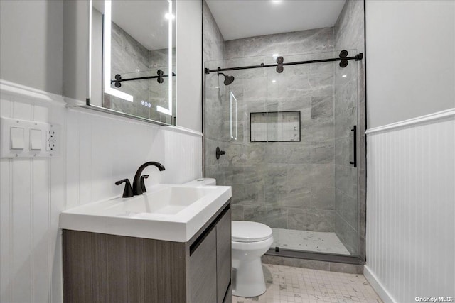 bathroom with tile patterned flooring, vanity, toilet, and a shower with shower door