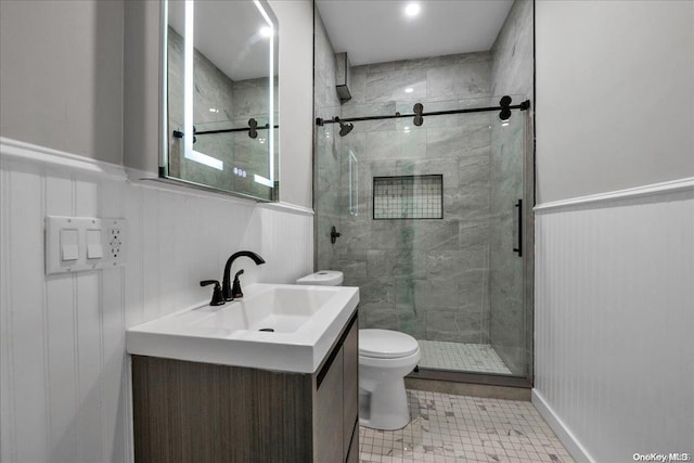 bathroom with tile patterned floors, vanity, toilet, and walk in shower