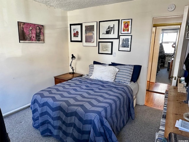 carpeted bedroom with a textured ceiling