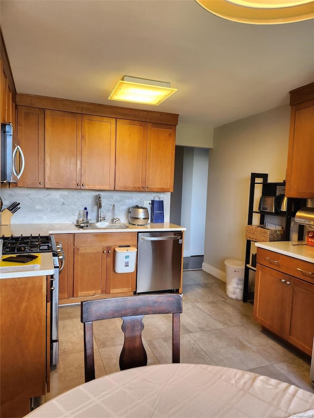 kitchen with light tile patterned floors, backsplash, stainless steel appliances, and sink