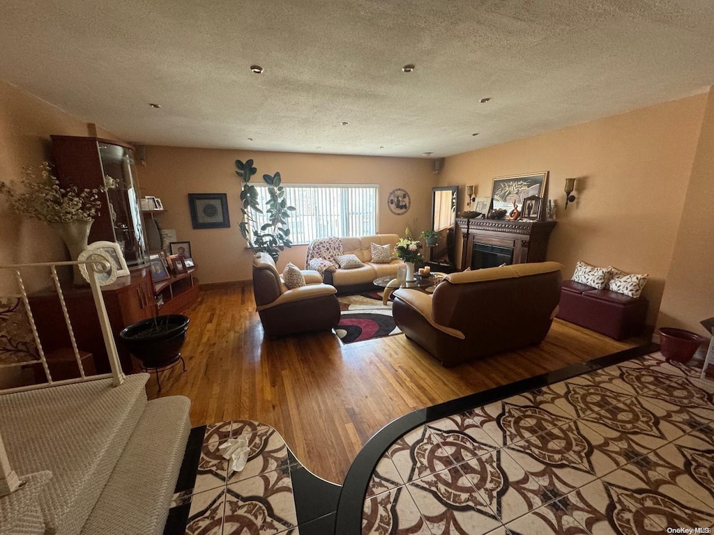 living room featuring hardwood / wood-style floors and a textured ceiling