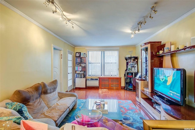 living room with crown molding, rail lighting, and hardwood / wood-style flooring