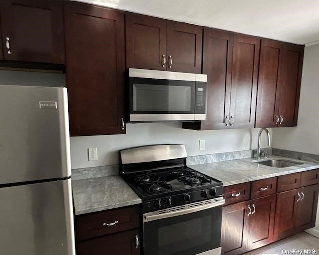 kitchen featuring light stone countertops, sink, and appliances with stainless steel finishes