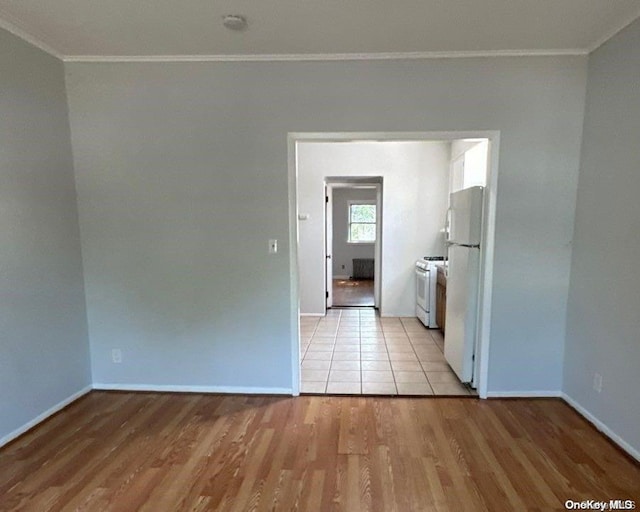 spare room with light hardwood / wood-style floors and ornamental molding