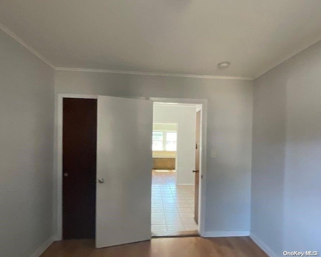 hallway featuring light hardwood / wood-style flooring and ornamental molding