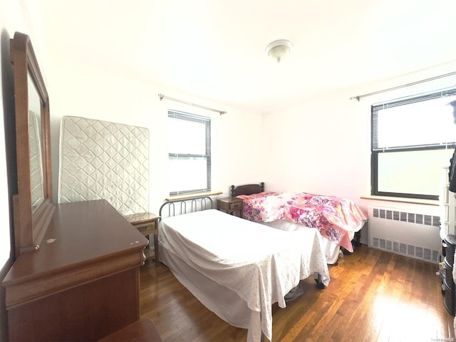 139-15 28th Rd Unit 6F, Flushing, NY 11354 - bedroom with radiator, multiple windows, and wood finished floors