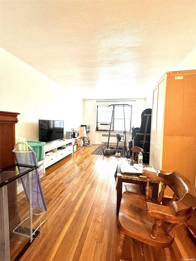 139-15 28th Rd Unit 6F, Flushing, NY 11354 - living room featuring wood finished floors and a textured ceiling