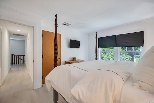 bedroom with light colored carpet and ornamental molding