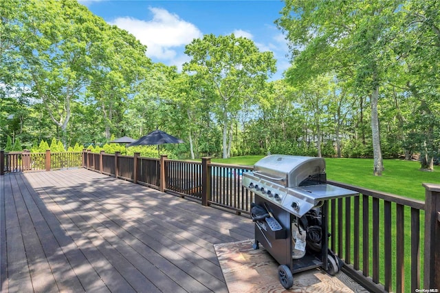 wooden deck with a lawn and grilling area