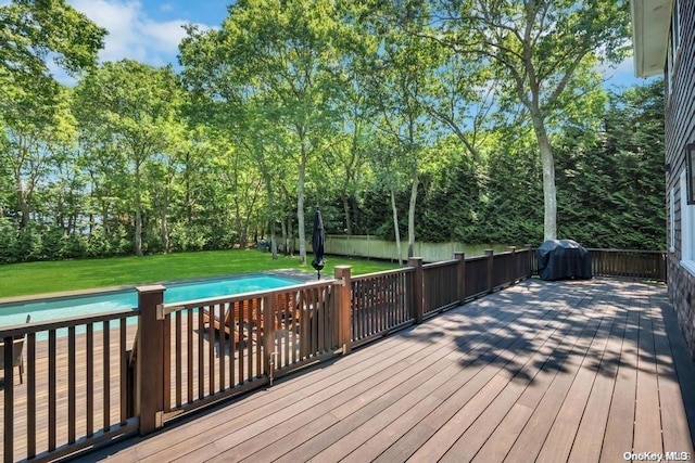 deck featuring a yard and grilling area