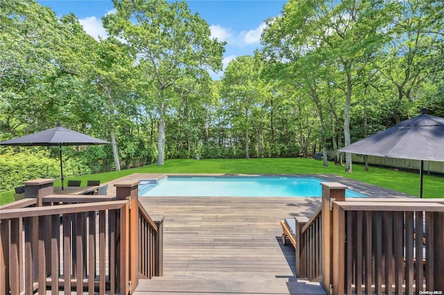 view of pool with a wooden deck and a yard