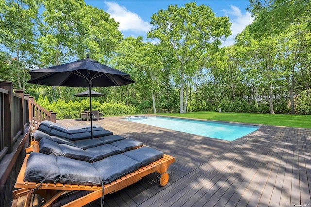 view of pool with a lawn and a deck