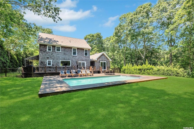 back of house featuring a yard and a deck