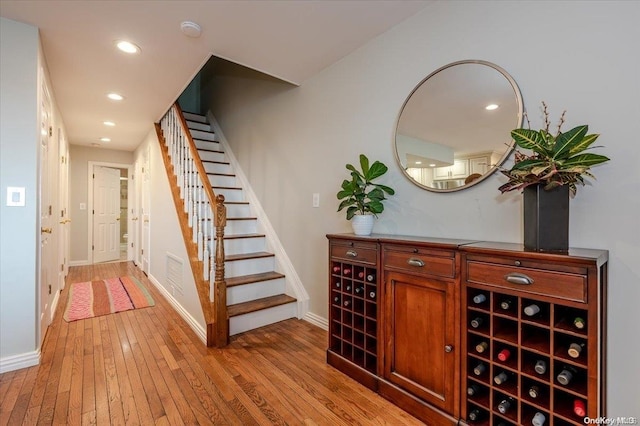 bar featuring light hardwood / wood-style floors