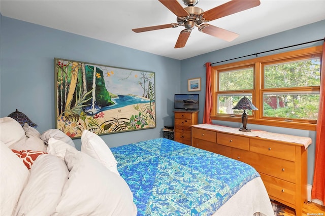 bedroom featuring ceiling fan and wood-type flooring