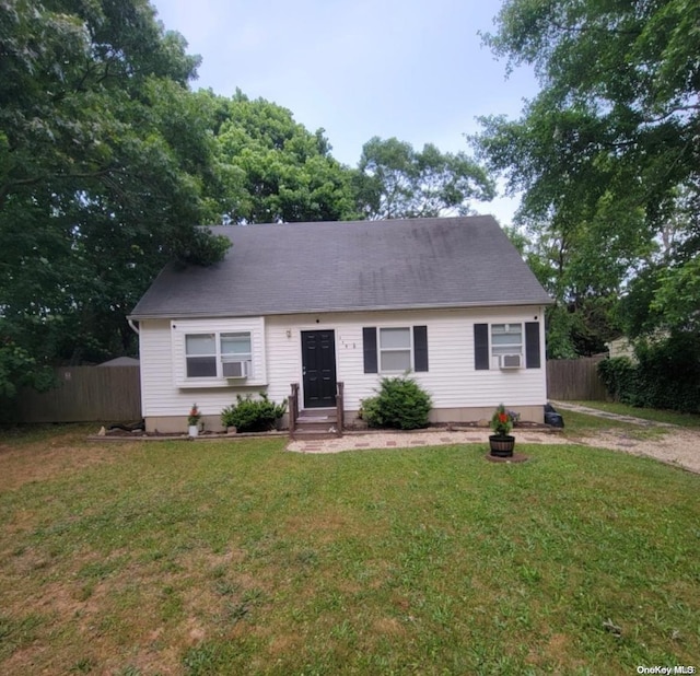 view of front of house with cooling unit and a front yard