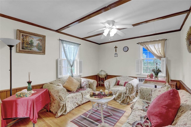 living room featuring ceiling fan, wood-type flooring, and ornamental molding