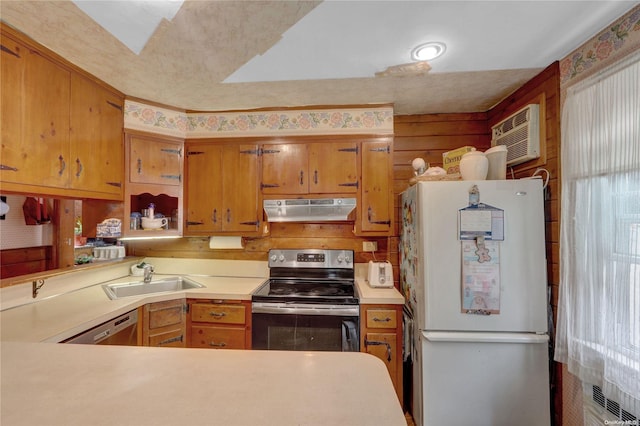 kitchen featuring kitchen peninsula, appliances with stainless steel finishes, a wall mounted AC, and sink