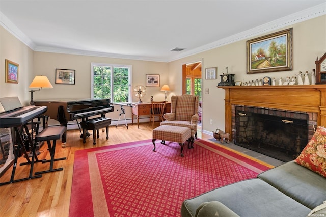 living room featuring a fireplace, wood-type flooring, crown molding, and a baseboard radiator