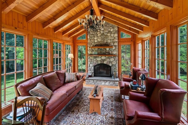 sunroom / solarium with wood ceiling, a fireplace, lofted ceiling with beams, and an inviting chandelier