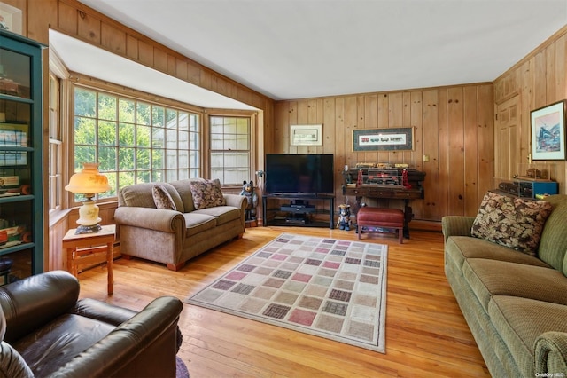 living room with hardwood / wood-style flooring and wooden walls