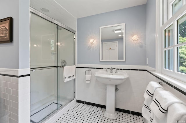 bathroom with a shower with shower door, tile walls, and radiator