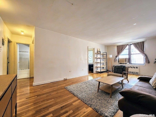 living room featuring hardwood / wood-style flooring and radiator heating unit