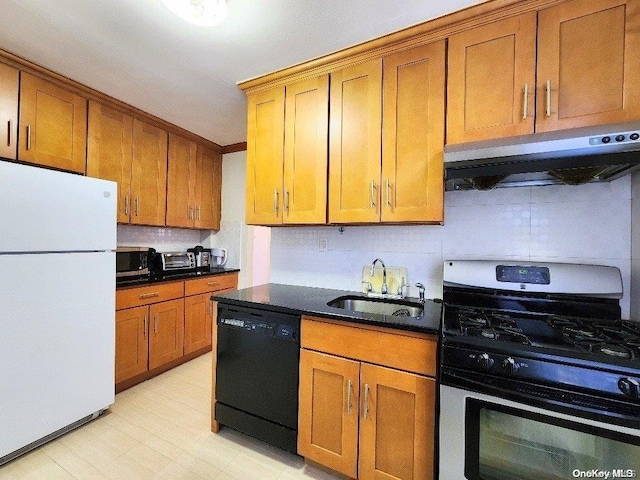 kitchen featuring exhaust hood, sink, stainless steel gas stove, black dishwasher, and white fridge