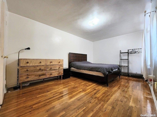 bedroom with dark hardwood / wood-style floors