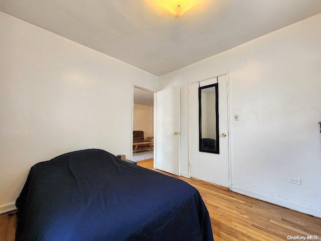 bedroom with hardwood / wood-style floors