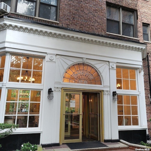 view of exterior entry with brick siding