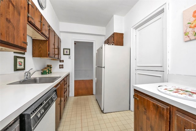 kitchen with light tile patterned flooring, sink, and white appliances