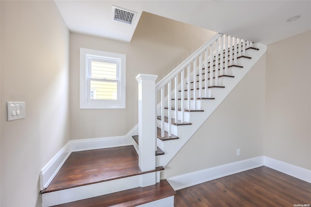 stairs featuring wood-type flooring