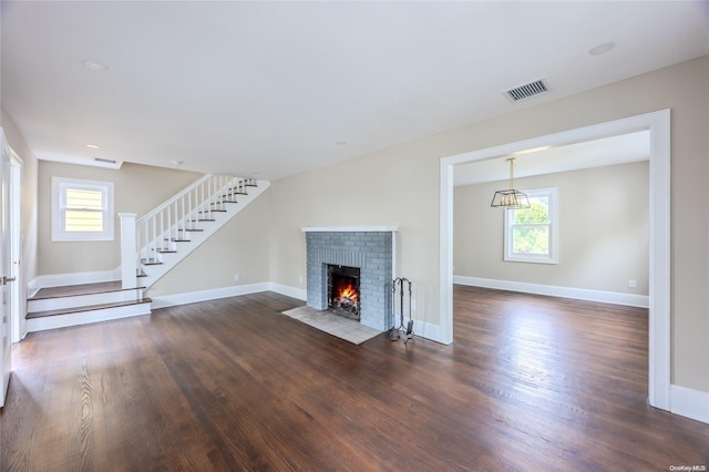 unfurnished living room with a fireplace and dark hardwood / wood-style floors