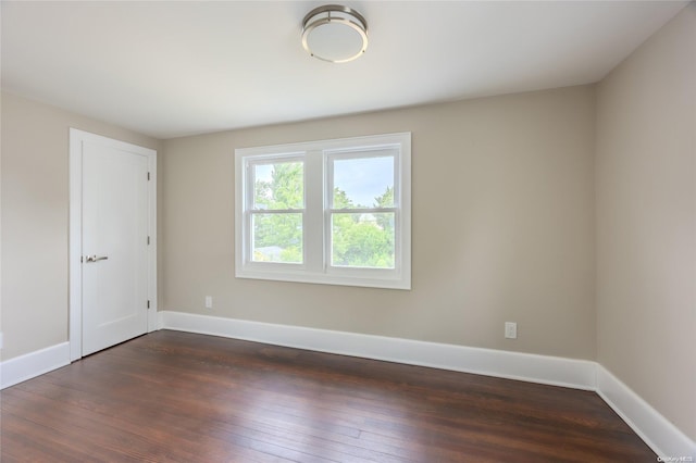 spare room with dark hardwood / wood-style floors