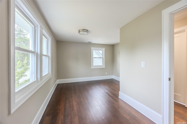 spare room featuring dark hardwood / wood-style flooring